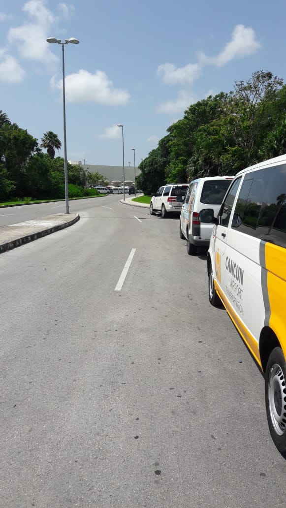 Luxury SUV and two Private Transfer vans at Cancun Airport